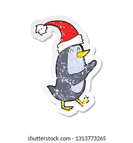 retro distressed sticker of a cartoon christmas penguin
