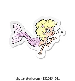 retro distressed sticker of a cartoon mermaid blowing kiss