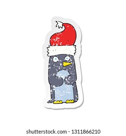 retro distressed sticker of a cartoon penguin in christmas hat