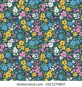 Retro floral pattern in small decorative flowers. Small blue, white, yellow pink flowers. Dark blue background. Ditsy print. Floral seamless background ditsy pattern in small cute wild flowers. 