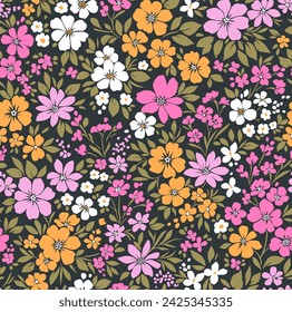 Retro floral pattern in small decorative flowers. Small pink, white, yellow flowers. Black background. Ditsy print. Floral seamless background ditsy pattern in small cute wild flowers.