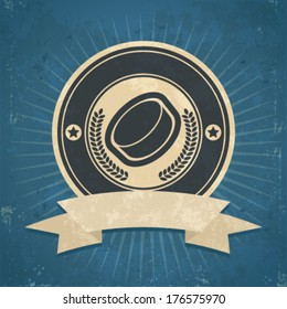 Retro grunge illustration of hockey puck emblem