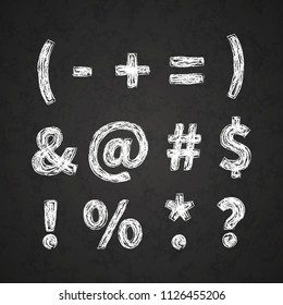Retro hand drawn alphabet letters drawing with white chalk on black chalkboard, vintage punctuation signs