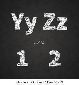 Retro hand drawn alphabet letters drawing with white chalk on black chalkboard, vintage Y, Z, 1, 2 letters