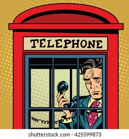 Retro man crying in a phone booth