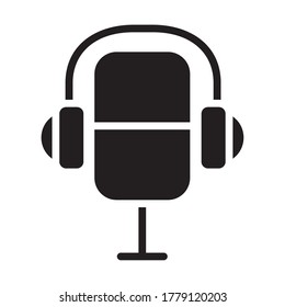 retro microphone with headphones icon over white background, silhouette style, vector illustration