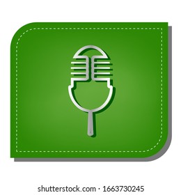 Retro microphone sign. Silver gradient line icon with dark green shadow at ecological patched green leaf. Illustration.