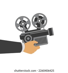 Retro movie camera in hand. Retro cinema projector.