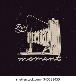 Retro photo camera with "Enjoy every moment" quote