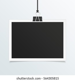 Retro photo frame mockup. White plastic border hanging on a clip on a light background. Realistic detailed Photo icon design template. Empty snapshot for your design. Vector illustration. EPS 10.