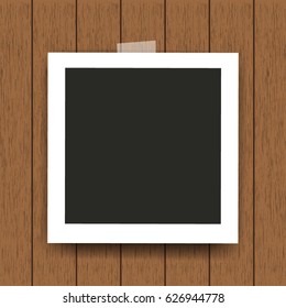Retro photo frame on wooden background