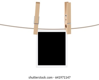 Retro photo frames hung on a rope with wooden clothespins.
