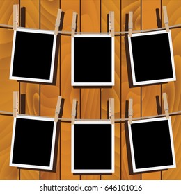 Retro photo frames hung on a rope with wooden clothespins.
