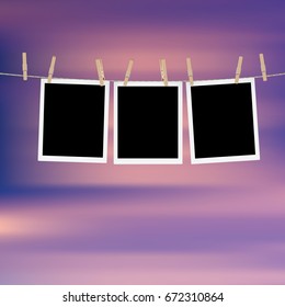 Retro photo frames hung on a rope with wooden clothespins.