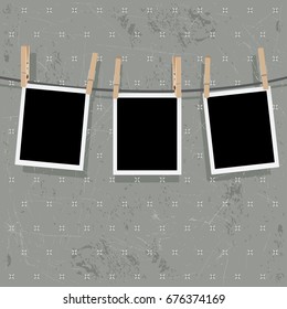Retro photo frames hung on a rope with wooden clothespins.