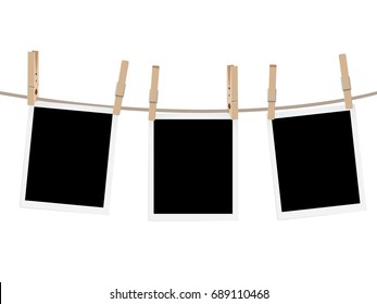 Retro photo frames hung on a rope with wooden clothespins.