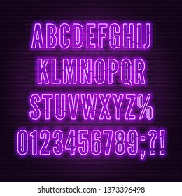 Retro purple neon alphabet with numbers on brick wall background.