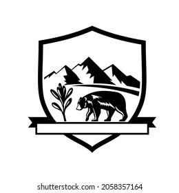 Retro style illustration of an American black bear walking towards sage herb plant with mountains in the background on set inside crest or shield isolated background done in black and white.