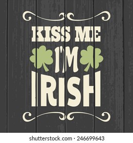 Retro style typographic design for Saint Patrick's Day on a gray wood background.