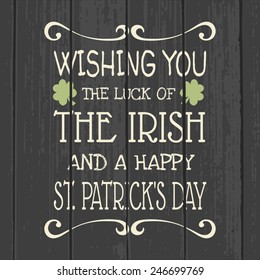 Retro style typographic design for Saint Patrick's Day on a gray wood background.