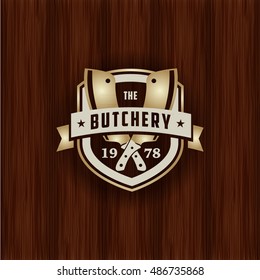 retro styled gold metal emblem of butcher meat shop logotype on aged wood texture cattle butcher animal classic product meat ranch knife swine natural killing metallic blaze nourishment timber market