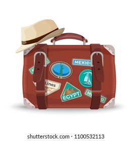 Retro suitcase with travel stickers and fedora hat
