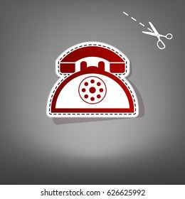 Retro telephone sign. Vector. Red icon with for applique from paper with shadow on gray background with scissors.
