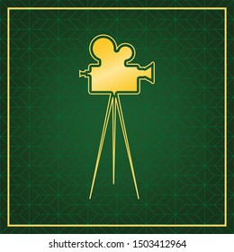 Retro video recording camera on tripod sign. Golden icon with gold contour at dark green gridded white background. Illustration.