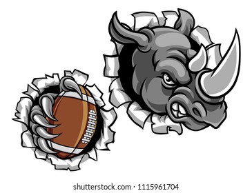 A rhino angry animal sports mascot holding an American football ball and breaking through the background with its claws