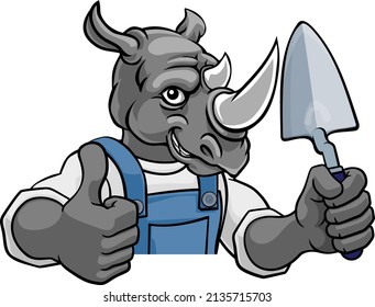 A rhino bricklayer builder construction worker mascot cartoon character holding a trowel tool and peeking around a sign giving a thumbs up