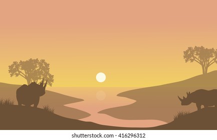 Rhino silhouette in riverbank at the morning