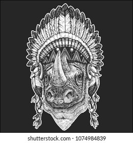Rhinoceros, rhino Cool animal wearing native american indian headdress with feathers Boho chic style Hand drawn image for tattoo, emblem, badge, logo, patch