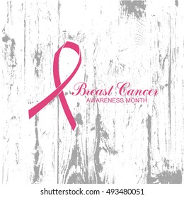 Ribbon of Breast Cancer on abstract wooden background.