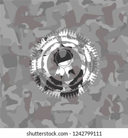 ribbon icon inside grey camo emblem