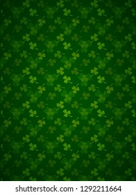 Rich green Saint Patrick's Day frame with four-leaf clover shamrock leaves pattern. Irish festival celebration greeting card design background. Vertical backdrop.