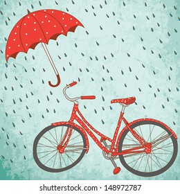 Reiten Sie mit Regenschirm ein Fahrrad im Regen