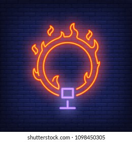Ring on fire neon icon. Circus flaming hoop on dark brick wall background. Night bright advertisement. Vector illustration in neon style for circus performance or dangerous trick