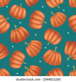 Ripe orange pumpkins with dots on a blue background. Autumn, vegetables. Seamless doodle food pattern. Suitable for packaging, textile, menu design.