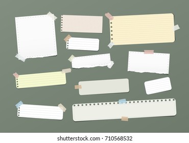 Ripped blank, ruled note, notebook, copybook paper strips stuck with colorful sticky tape on green background.