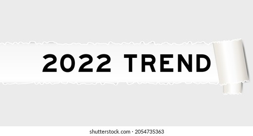 Ripped gray paper background that have word 2022 trend under torn part