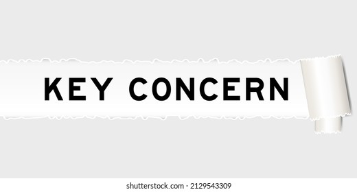 Ripped gray paper background that have word key concern under torn part