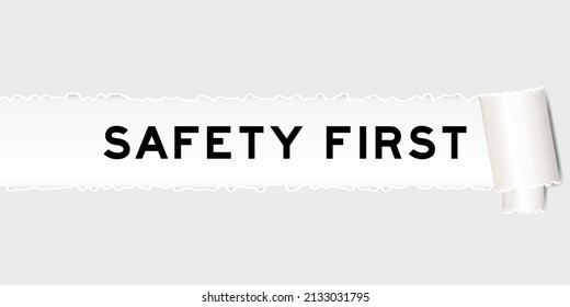 Ripped gray paper background that have word safety first under torn part