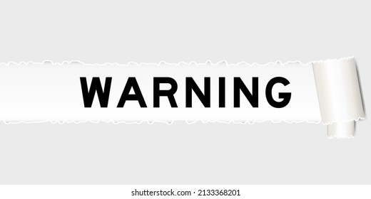 Ripped gray paper background that have word warning under torn part