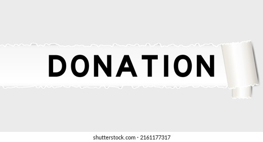 Ripped gray paper background that have word donation under torn part