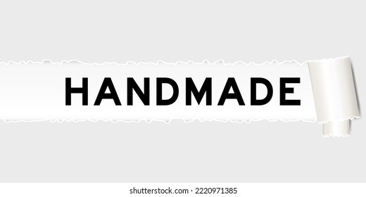 Ripped gray paper background that have word handmade under torn part