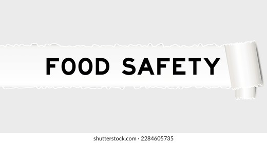 Ripped gray paper background that have word food safety under torn part