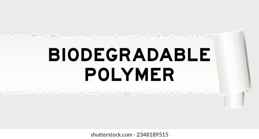 Ripped gray paper background that have word biodegradable polymer under torn part
