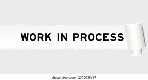 Ripped gray paper background that have word work in process under torn part
