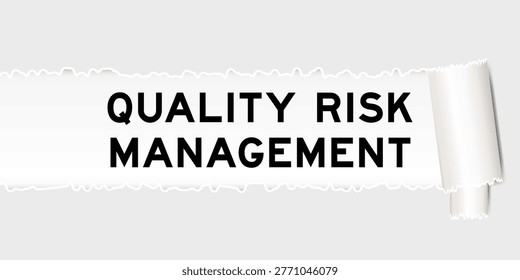 Ripped gray paper background that have word quality risk management under torn part