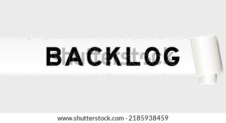 Ripped gray paper background that have word backlog under torn part